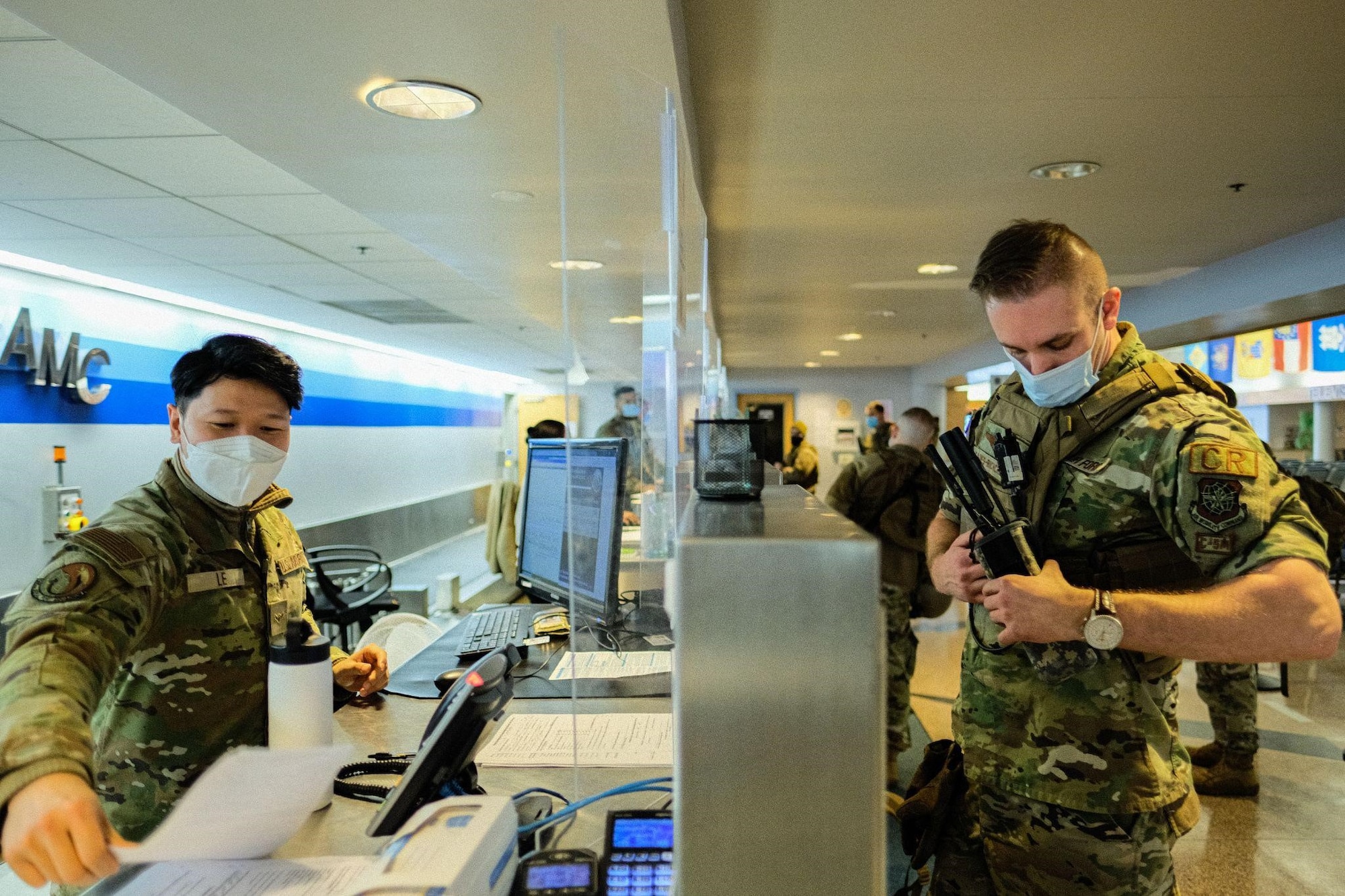 U.S. Air Force Airman Khanh Bao Le, 305th Aerial Port Squadron passenger terminal agent, checks in a service member assigned to the 621st Contingency Response Wing as part of exercise Jersey Devil at Joint Base McGuire-Dix-Lakehurst, N.J., Jan. 11, 2023. Jersey Devil 23, a U.S. Air Force mobility exercise hosted by the 621st CRW, tests the abilities of multi-capable airmen to rapidly deploy, establish and control airbases alongside joint allies and partners. (U.S. Air Force photo by Senior Airman Joseph Morales)