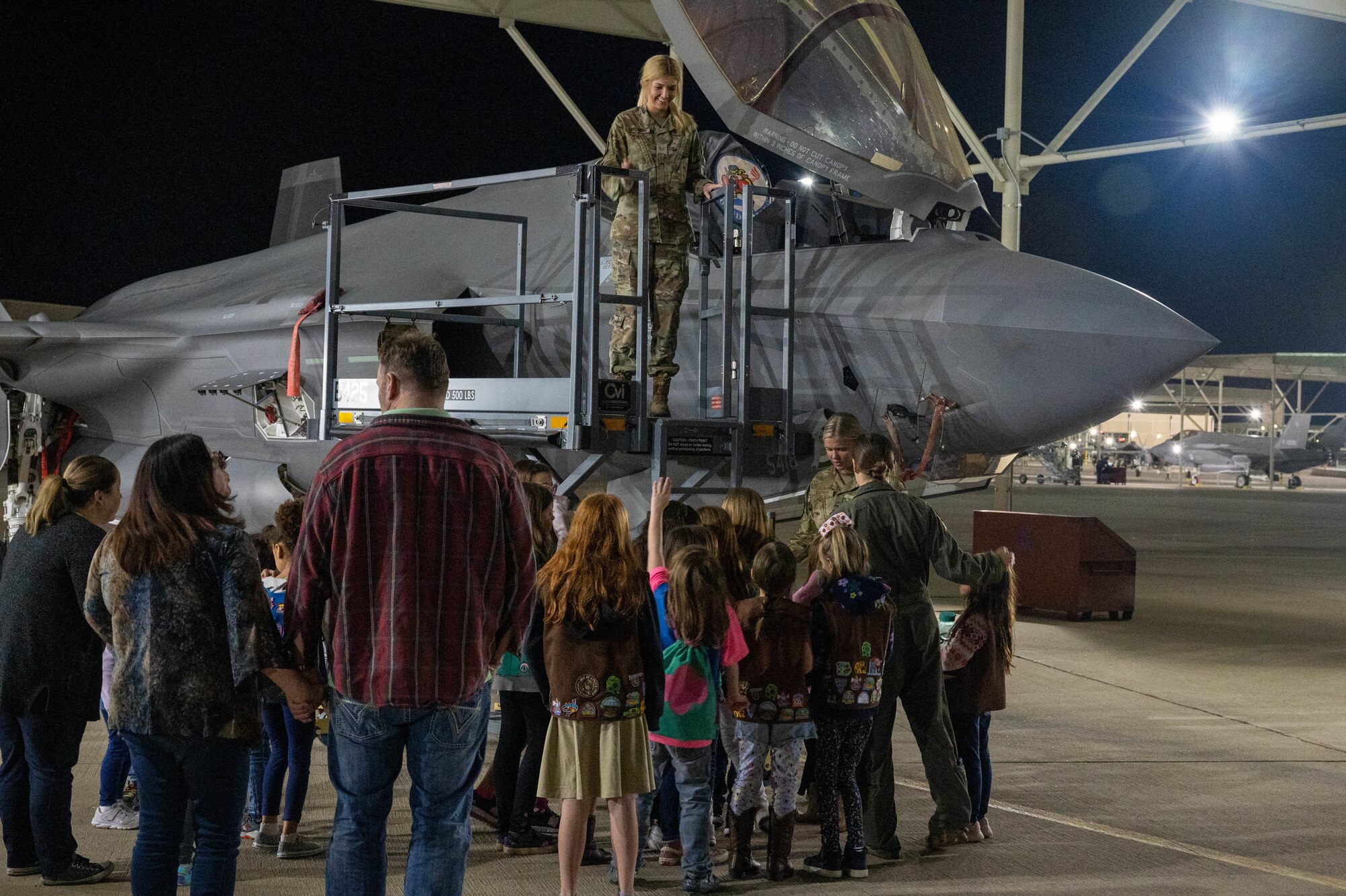 U.S. Air Force Airmen from the 62nd Fighter Squadron and 62nd Aircraft Maintenance Unit showcase an F-35A Lightning II aircraft to a local Girl Scouts troop Jan. 11, 2023, at Luke Air Force Base, Arizona.