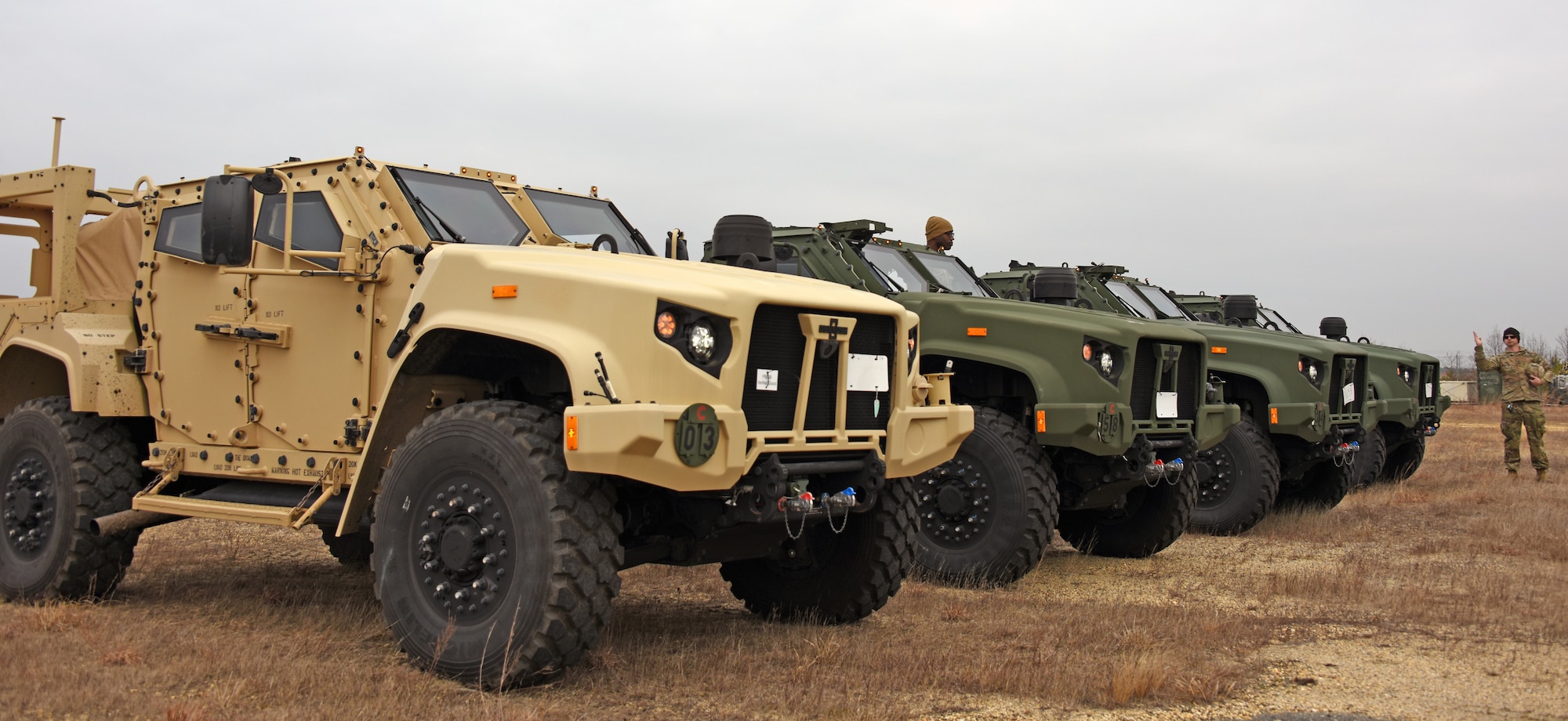 U.S. Army Staff Sgt. Paul Hendrickson, 439th Multifunctional Medical Battalion motor sergeant, directs U.S. Army soldiers to park joint light tactical vehicles in preparation for the Jersey Devil 23 exercise.
