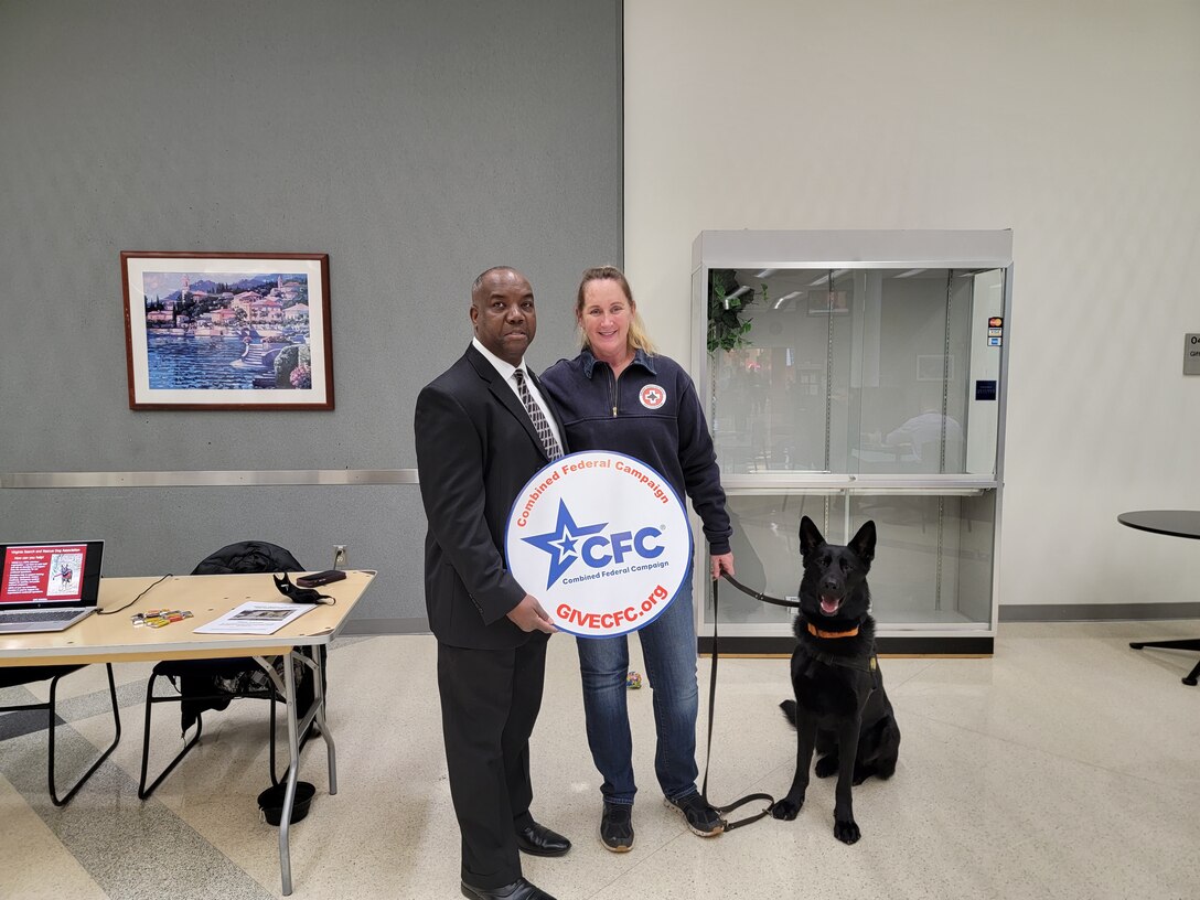 two people behind a table holding cfc logo