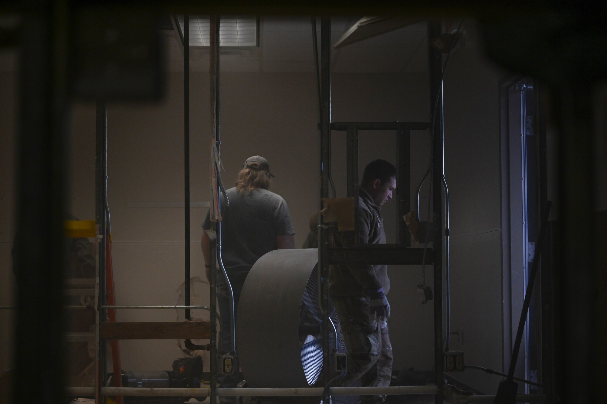 Men remove drywall.