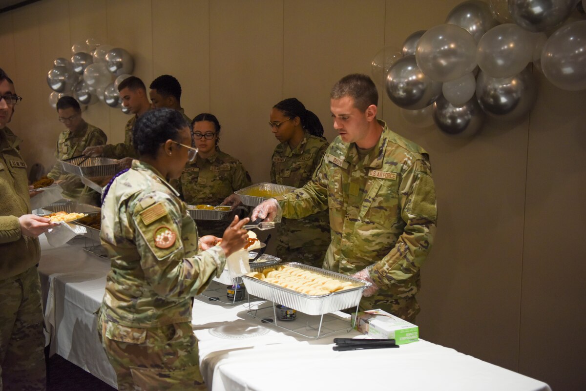 Goodfellow Airmen serve members of the 17th Training Wing before the MLK observance day event on Goodfellow Air Force Base, Texas, 13 Jan., 2023. Members partook in southern-style food and came together to socialize with fellow service members. (U.S. Air Force Photo by Staff Sgt. Tyrell Hall)