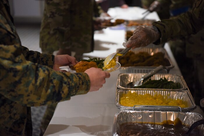A Goodfellow student serves a fellow member before the MLK observance day event on Goodfellow Air Force Base, Texas, 13 Jan., 2023. MLK Day is a holiday celebrated each year to remember Dr. Martin Luther King Jr.’s impact and message of equality. (U.S. Air Force Photo by Staff Sgt. Tyrell Hall)