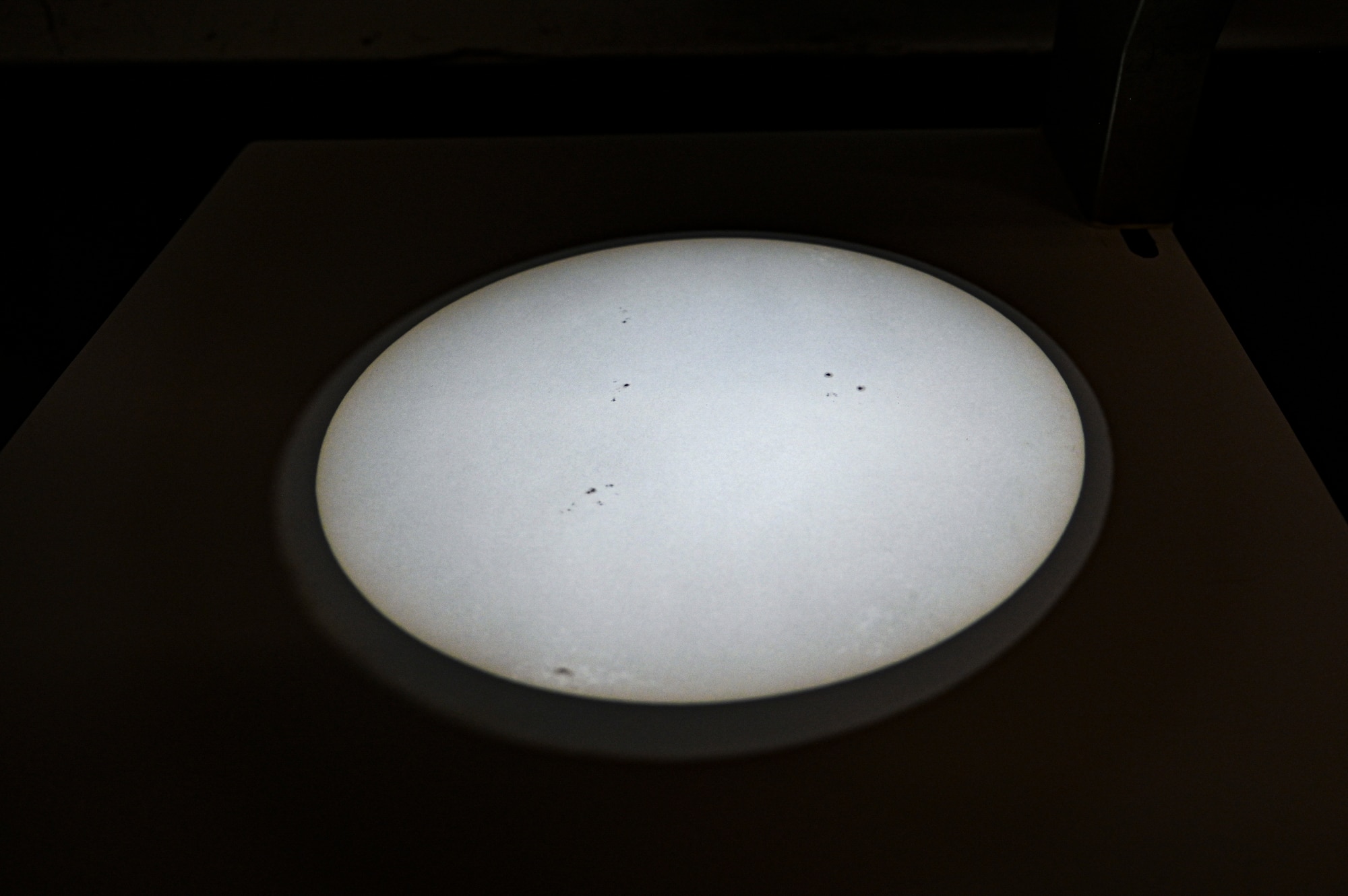 An image of the sun can be seen through a light projection casted by telescope at Holloman Air Force Base, New Mexico, Jan. 6, 2023. The light projection from the telescope is used to locate and measure sunspots representing cooler sections on the sun's surface. (U.S. Air Force photo by Airman 1st Class Isaiah Pedrazzini)