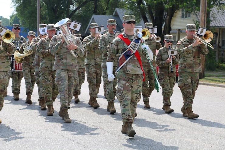 1ST INFANTRY DIVISION BAND marching down the road.