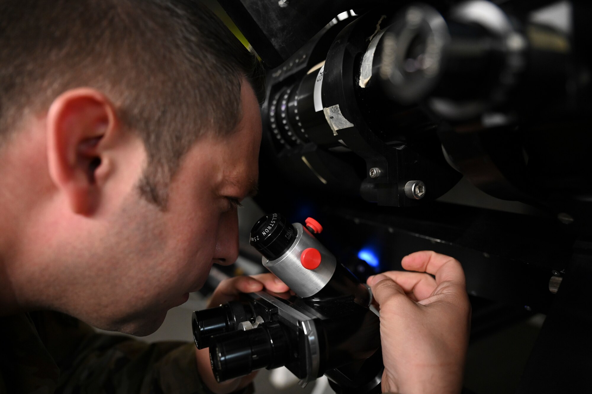 U.S. Air Force Tech. Sgt. Sergio Martinez, 2nd Weather Squadron radar airfield and weather systems noncommissioned officer in charge, looks through the eyepiece of the observatory telescope at Holloman Air Force Base, New Mexico, Jan. 6, 2023. The eyepiece provides Airmen of the 2nd WS a direct line of sight to solar activities visible to the naked eye. (U.S. Air Force photo by Airman 1st Class Isaiah Pedrazzini)