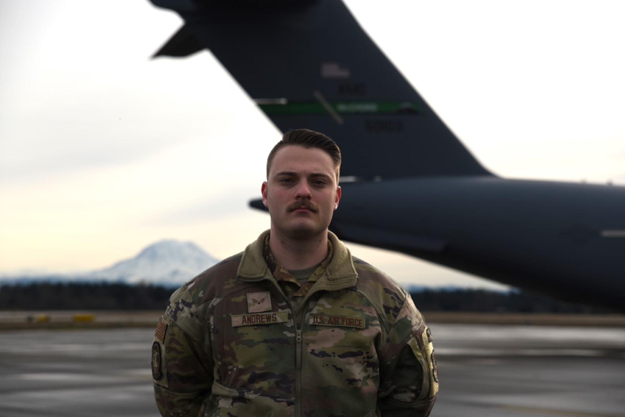U.S. Air Force Senior Airman Austin Andrews, a loadmaster with the 4th Airlift Squadron, poses for a photo on the flightline at Joint Base Lewis-McChord, Washington, Jan. 4, 2023. In 2022, Andrews was awarded the Staff Sgt. Henry E. “Red” Erwin award. This award is given annually to one flight engineer, loadmaster, air surveillance operator or other related career field for their outstanding leadership and sustained self-improvements in support of enlisted aircrew operations. (U.S. Air Force photo by Airman Kylee Tyus).