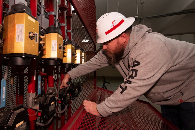 James Riley, Powerplant senior operator at Wolf Creek Dam on the Cumberland River in Jamestown, Kentucky, turns off a CO2 unit during an inspection of a power unit inside the hydropower plant Jan. 10, 2023. He supervises and operates hydropower and spillway gate equipment in support of the flood risk management mission at the project. (USACE Photo by Lee Roberts)