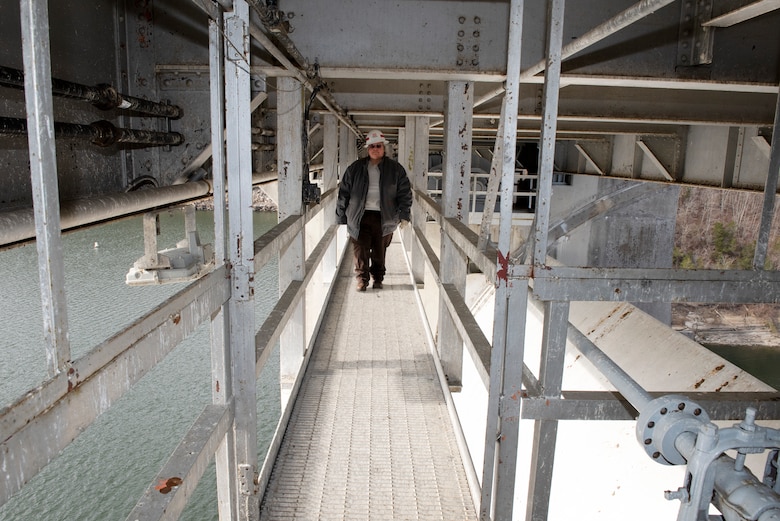 Deborah Greene, hydropower mechanic, moves along a walkway while inspection spillway gate machinery Jan. 10, 20923, at Wolf Creek Dam on the Cumberland River in Jamestown, Kentucky. She operates and maintains hydropower and spillway gate equipment in support of the flood risk management mission at the project. (USACE Photo by Lee Roberts)