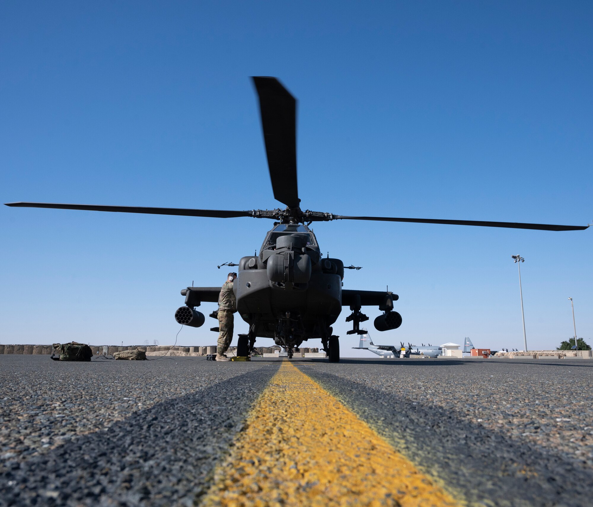 A U.S. Army AH-64E Apache helicopter from Task Force Rough Riders powers down after landing at Ali Al Salem Air Base, Kuwait, Jan. 11, 2023.