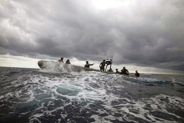 Coast Guardsmen assigned to Tactical Law Enforcement Team 109, Cape Cod Maritime Safety Security Team, and Sailors assigned to USS Sioux City, participate in noncompliant
vessel pursuit tactics exercise in rigid-hull inflatable boat, Atlantic Ocean, April 1, 2021 (U.S. Navy/Marianne Guemo)