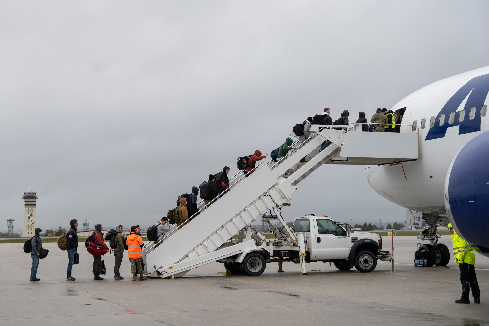 Airmen line up to board a Boeing 767.