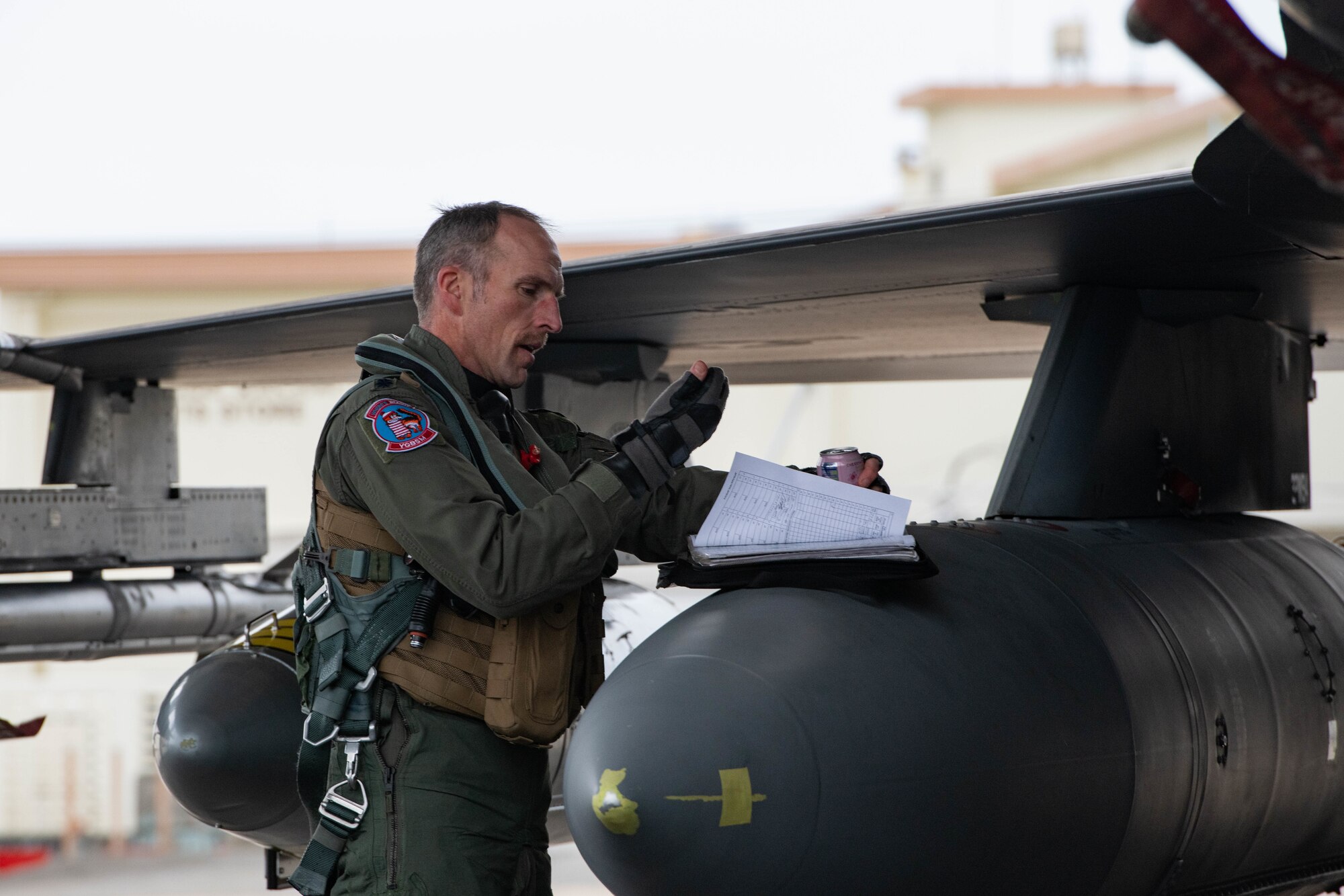 An Airman reviews maintenance logs.