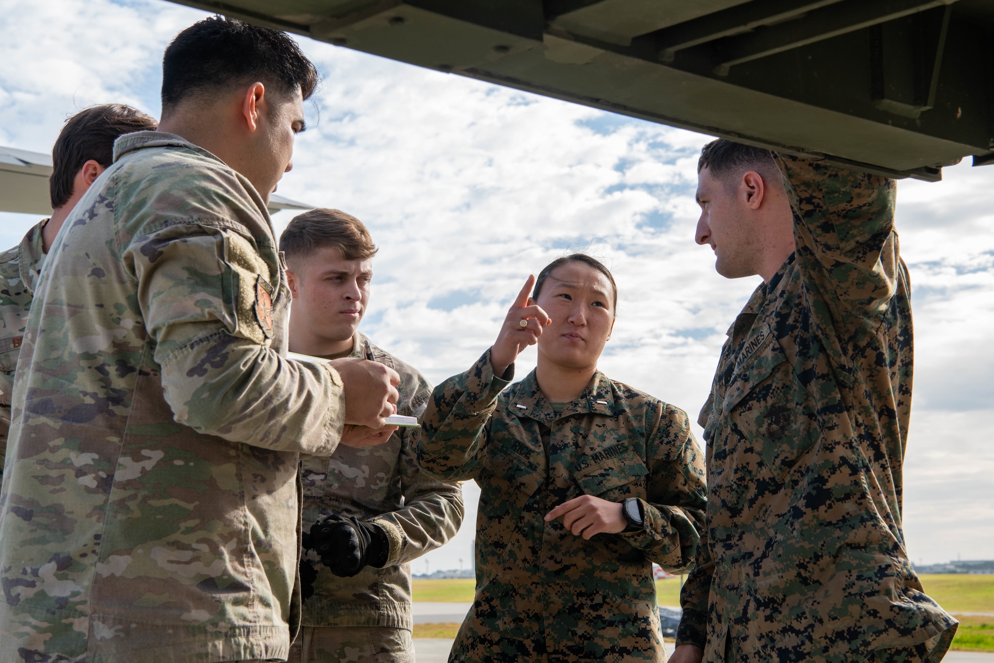 Airmen and Marines discuss ideas.