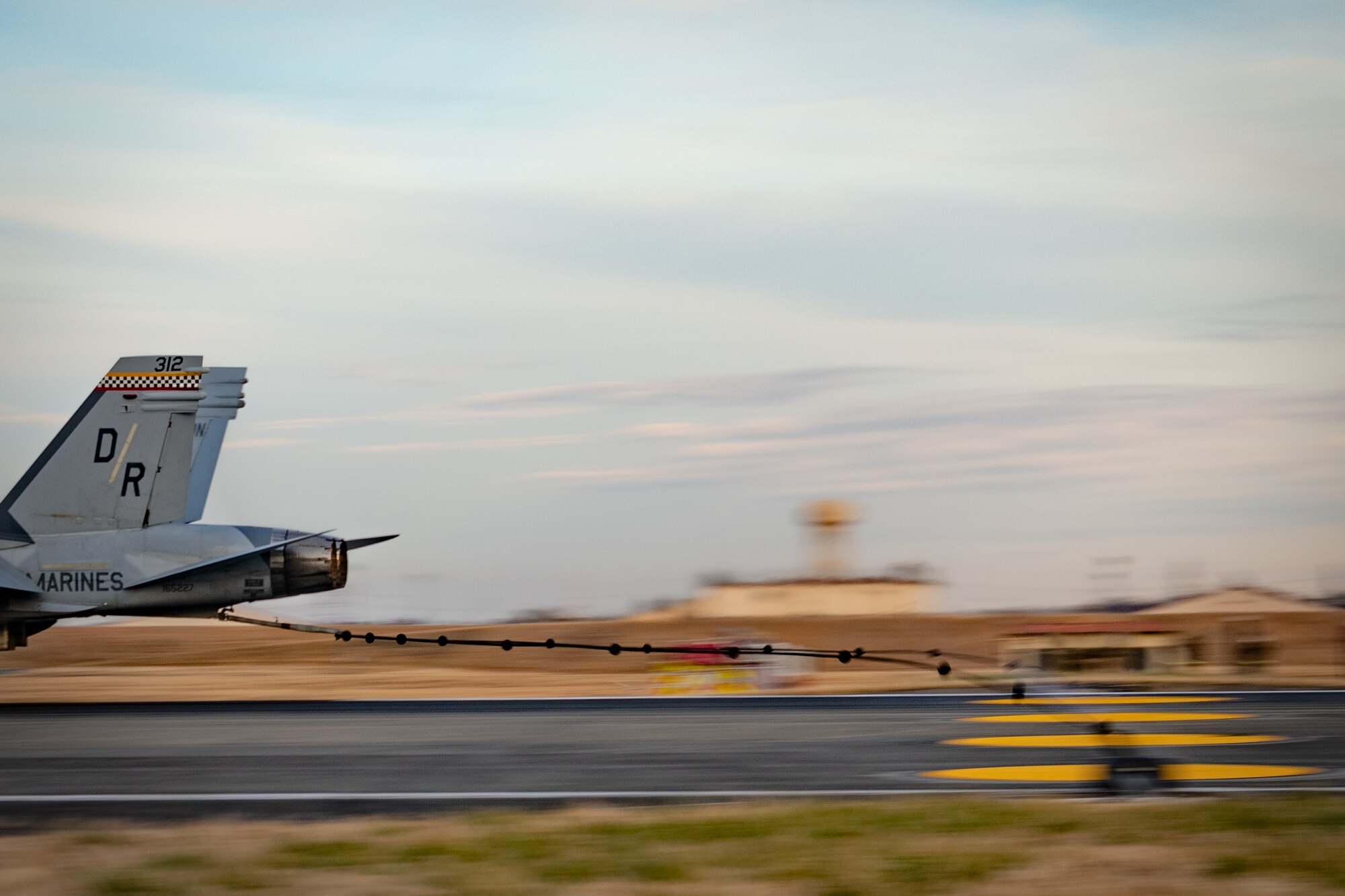 A U.S. Marine Corps F/A-18C Hornet, assigned to Marine Fighter Attack Squadron (VMFA) 312, Marine Corps Air Station Beaufort, South Carolina, catches an Aircraft Arresting System (AAS) cable during an annual certification at Yokota Air Base, Japan, Jan. 6, 2023.