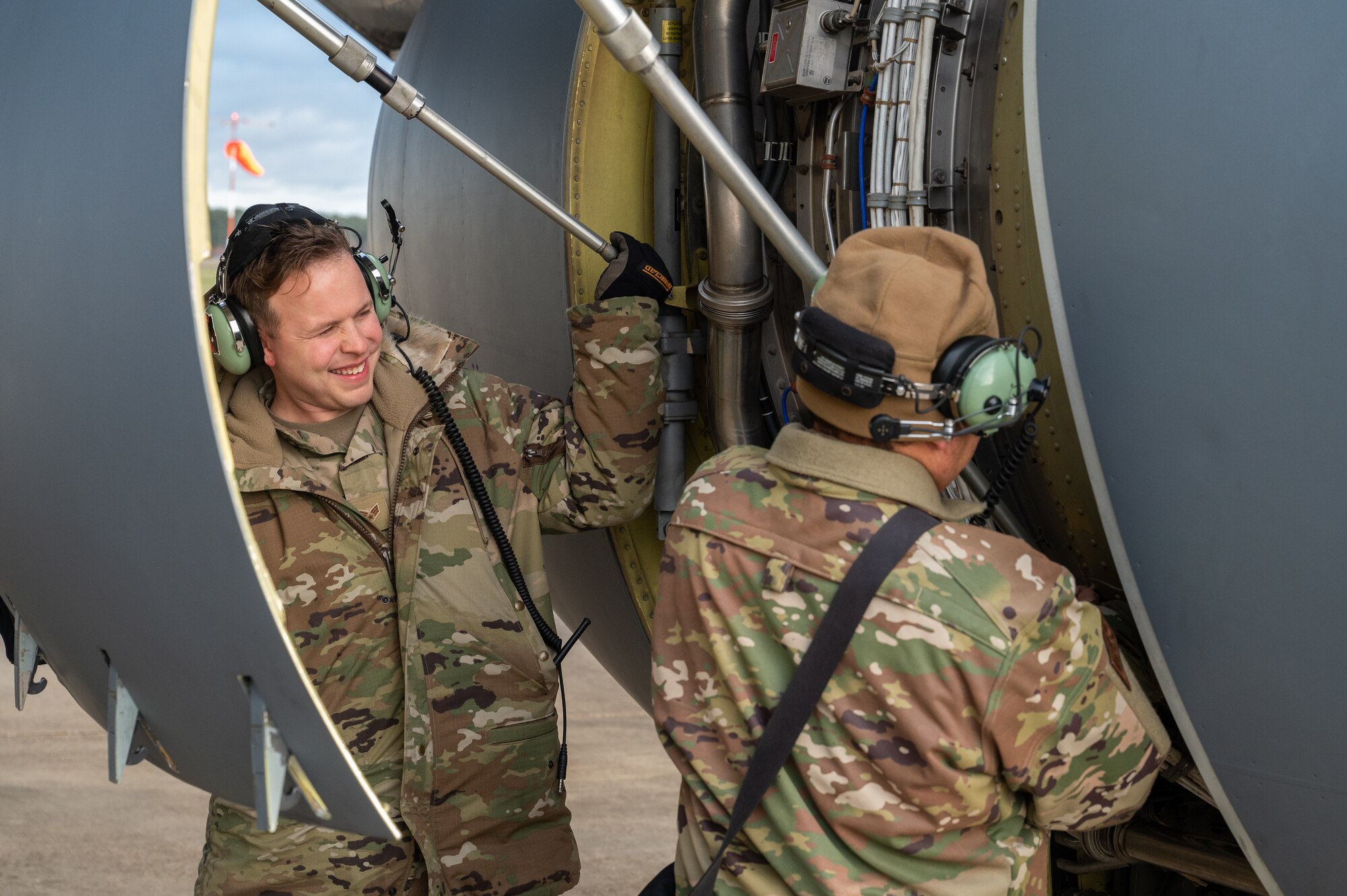 U.S. Air Force Senior Airman Eric Ridout, left, 100th Aircraft Maintenance Squadron aerospace propulsion journeyman, and Staff Sgt. Christopher Bell, right, 100th AMXS aerospace propulsion journeyman, prepare to close the KC-135 Stratotanker aircraft side engine covers on the flightline, Jan. 9, 2023, at Royal Air Force Mildenhall, England.