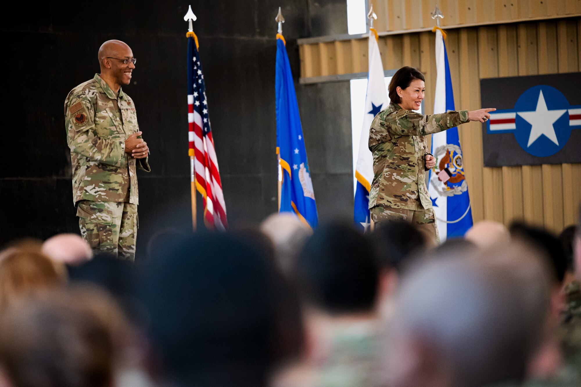 Air Force Chief of Staff Gen. CQ Brown, Jr., and Chief Master Sgt. of the Air Force JoAnne S. Bass answer questions during an All-Call with Airmen and Guardians at Al Dhafra Air Base, United Arab Emirates, Jan. 8, 2023. Gen. Brown and Chief Bass conducted an All-Call at Al Dhafra AB. Their stop in Al Dhafra AB was one of many across Air Force Central Command to recognize and thank Airmen and Guardians “Standing Watch,” remaining vigilant and on call 24 hours a day to protect U.S., allies and partners’ national security. (U.S. Air Force photo by Staff Sgt. Sabatino DiMascio)