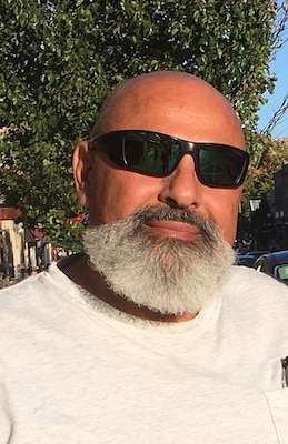 Portrait photo of a man wearing sunglasses.