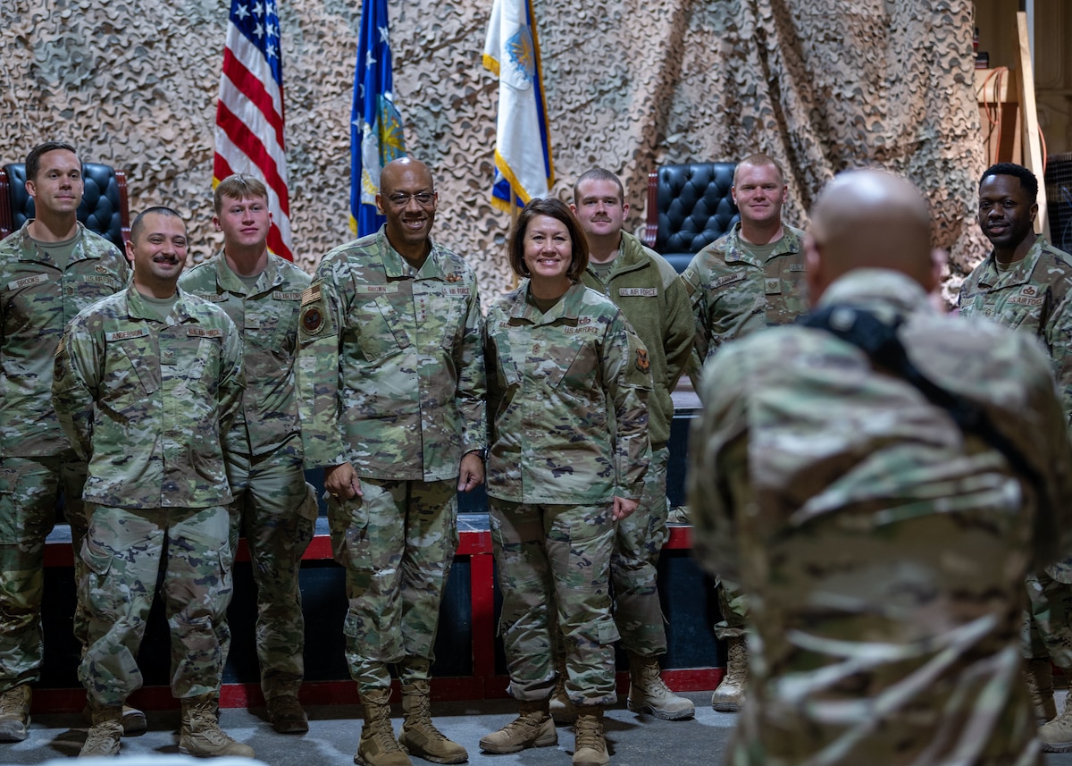 Air Force Chief of Staff Gen. CQ Brown, Jr and Chief Master Sgt. of the Air Force JoAnne S. Bass pose for a group photo taken by Tech Sgt. Richard Mekkri, 332 Air Expeditionary Wing, Public Affairs, at an undisclosed location, Southwest Asia January 8, 2023. The wing all-call discussed National Defense Strategy, agile combat employment, multi-capable Airmen, and the spectrum of resiliency. (U.S. Air Force photo by 1st Lt. Michael Luangkhot)