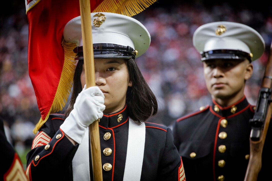 Close-up of Marines participating in the presentation of the colors at an NFL game.