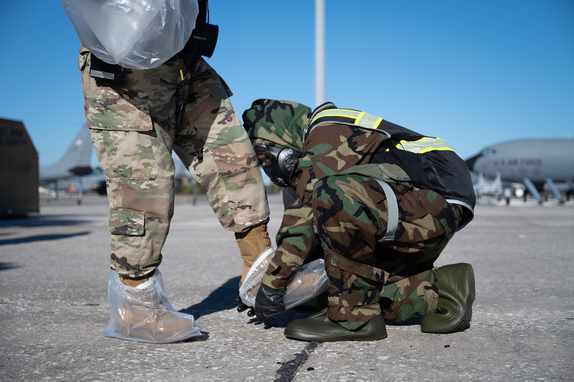 Citizen Airmen from the 927th Air Refueling Wing, MacDill Air Force Base, Fla., simulate removing contaminated equipment and clothing in a decontamination line Jan. 8, 2023. Maintaining readiness is a top priority during the unit training assembly weekends for Reserve Airmen at the 927th ARW. (U.S. Air Force photo by Staff Sgt. Alexis Suarez)