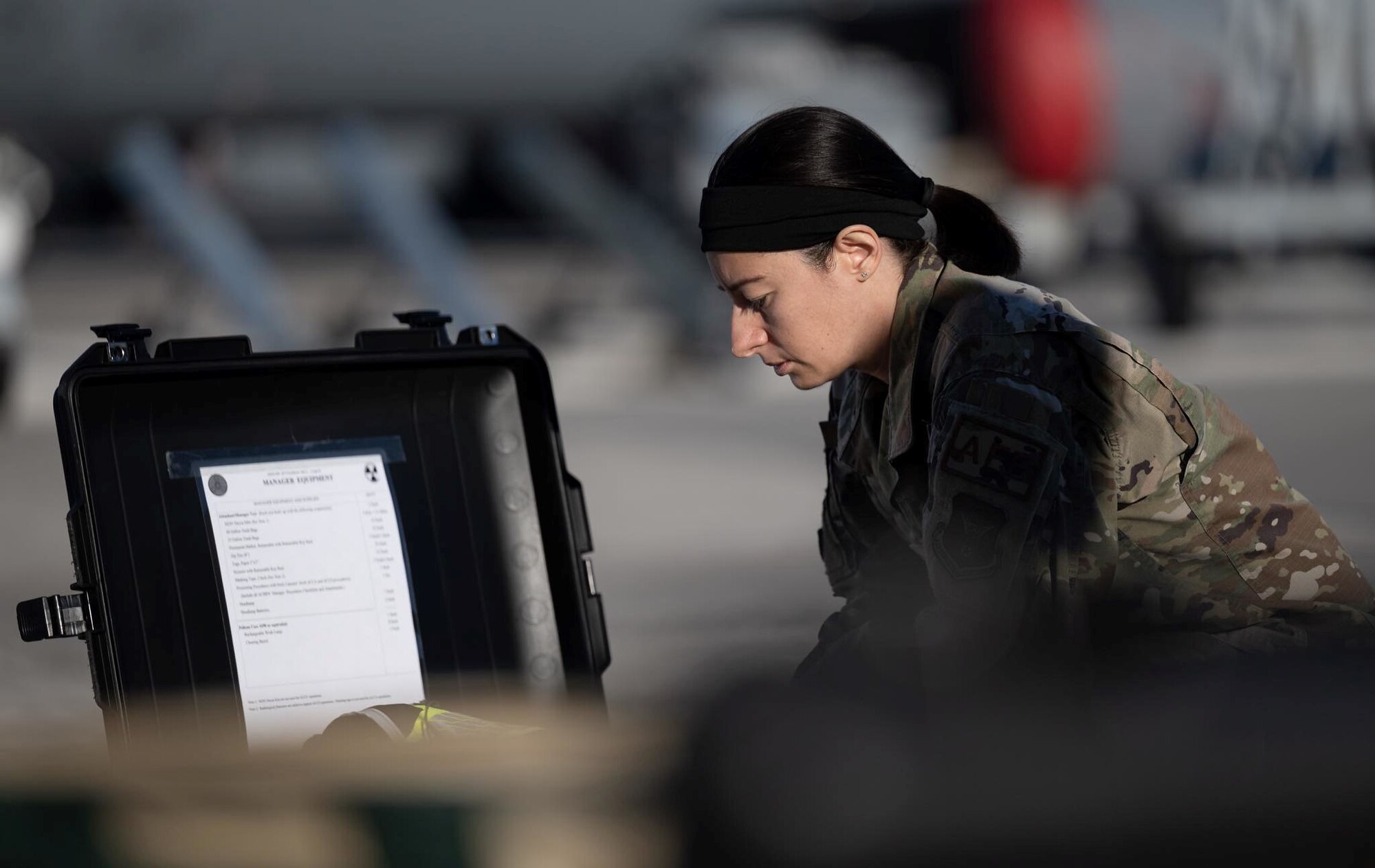 U.S. Air Force Master Sgt. Katia Cordon Aldana, Aircrew Flight Equipment Craftsman, 927th Operations Support Squadron, MacDill Air Force Base, Fla., inspects equipment prior to setting up and executing a decontamination line. Maintaining readiness is a top priority during the unit training assembly weekends for Reserve Airmen at the 927th ARW. (U.S. Air Force photo by Tech Sgt. Brad Tipton)