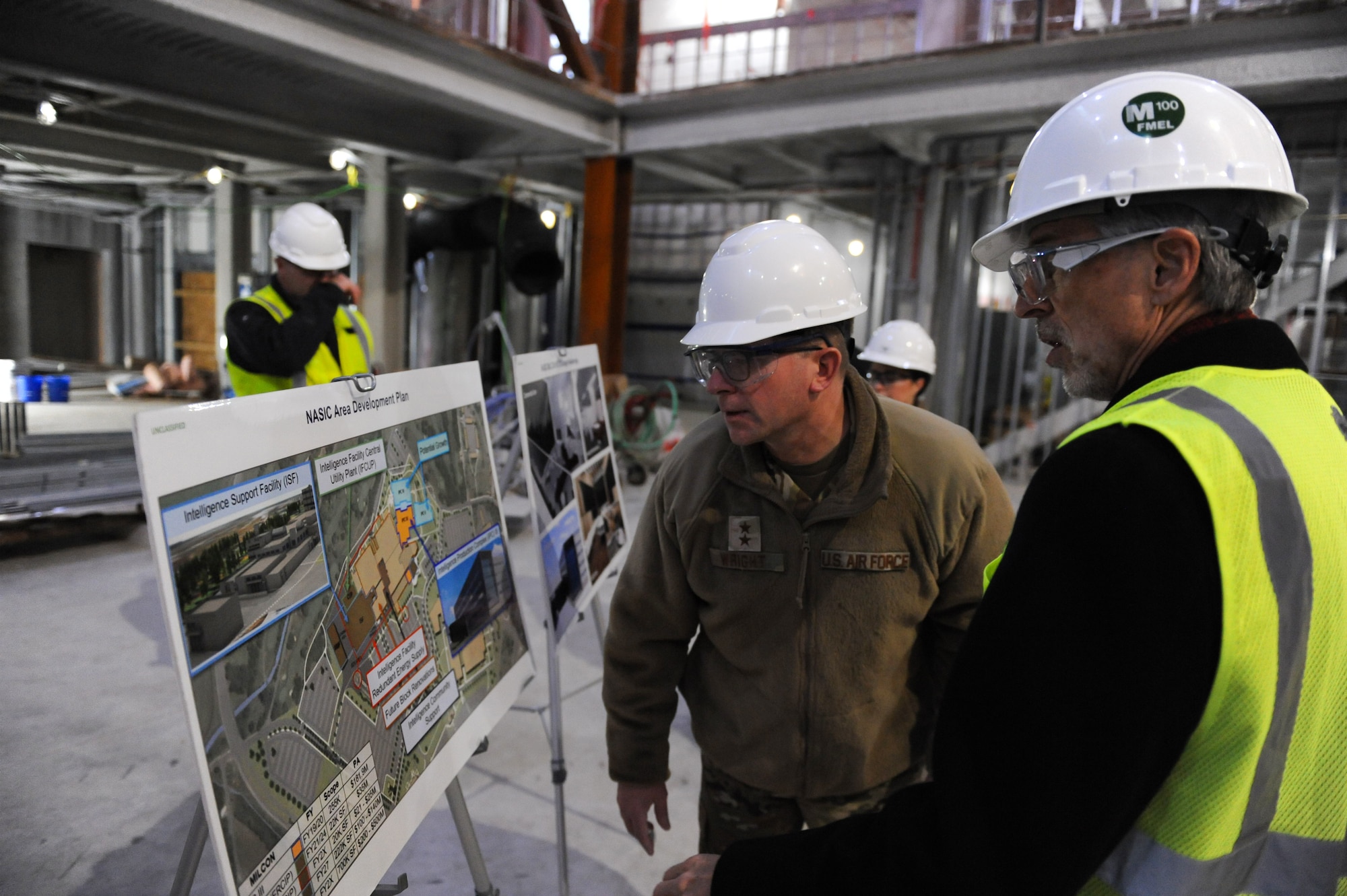 Maj. Gen. Parker H. Wright, Intelligence and Information director, North American Aerospace Defense Command and United States Northern Command, takes a closer look at the National Air and Space Intelligence Center area development plan as he toured the ongoing construction of the Intelligence Production Center III at Wright-Patterson Air Force Base, Ohio, Jan. 11, 2023. David Bek, NASIC’s Facilities and Logistics director provided information to Wright throughout the tour on specific projects the construction team was working on within the IPC III.
