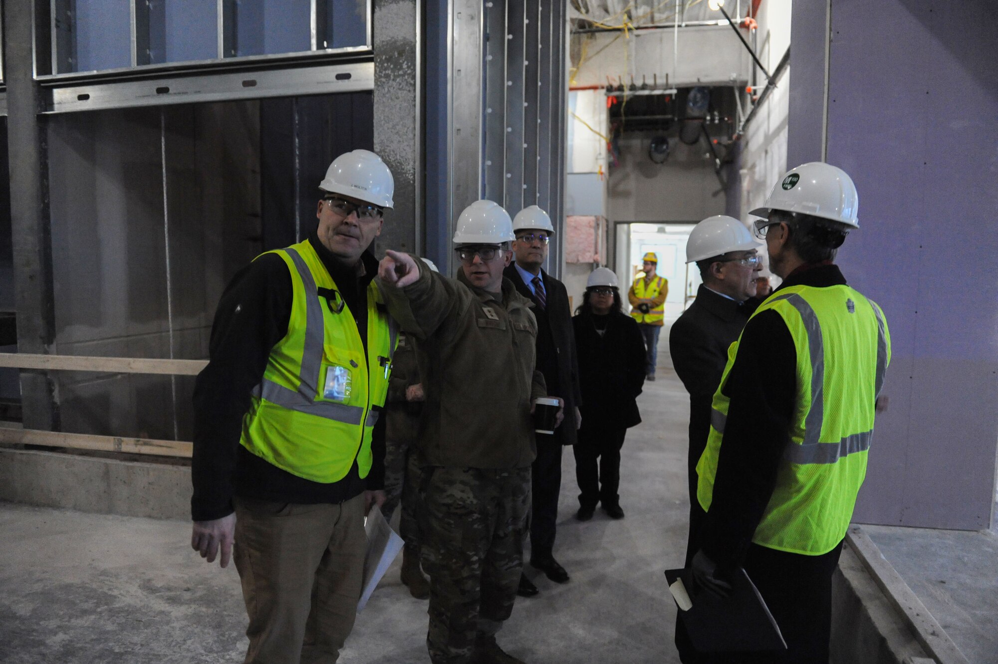 Maj. Gen. Parker H. Wright, Intelligence and Information director, North American Aerospace Defense Command and United States Northern Command, points to a newly constructed area within the Intelligence Production Center III during his tour of the building at Wright-Patterson Air Force Base, Ohio, Jan. 11, 2023. Expected to finish in 2024, the 255,000 square-foot building will add 980 workstations, mission-specific functions, meeting areas, and advanced visualization capabilities to the NASIC campus.