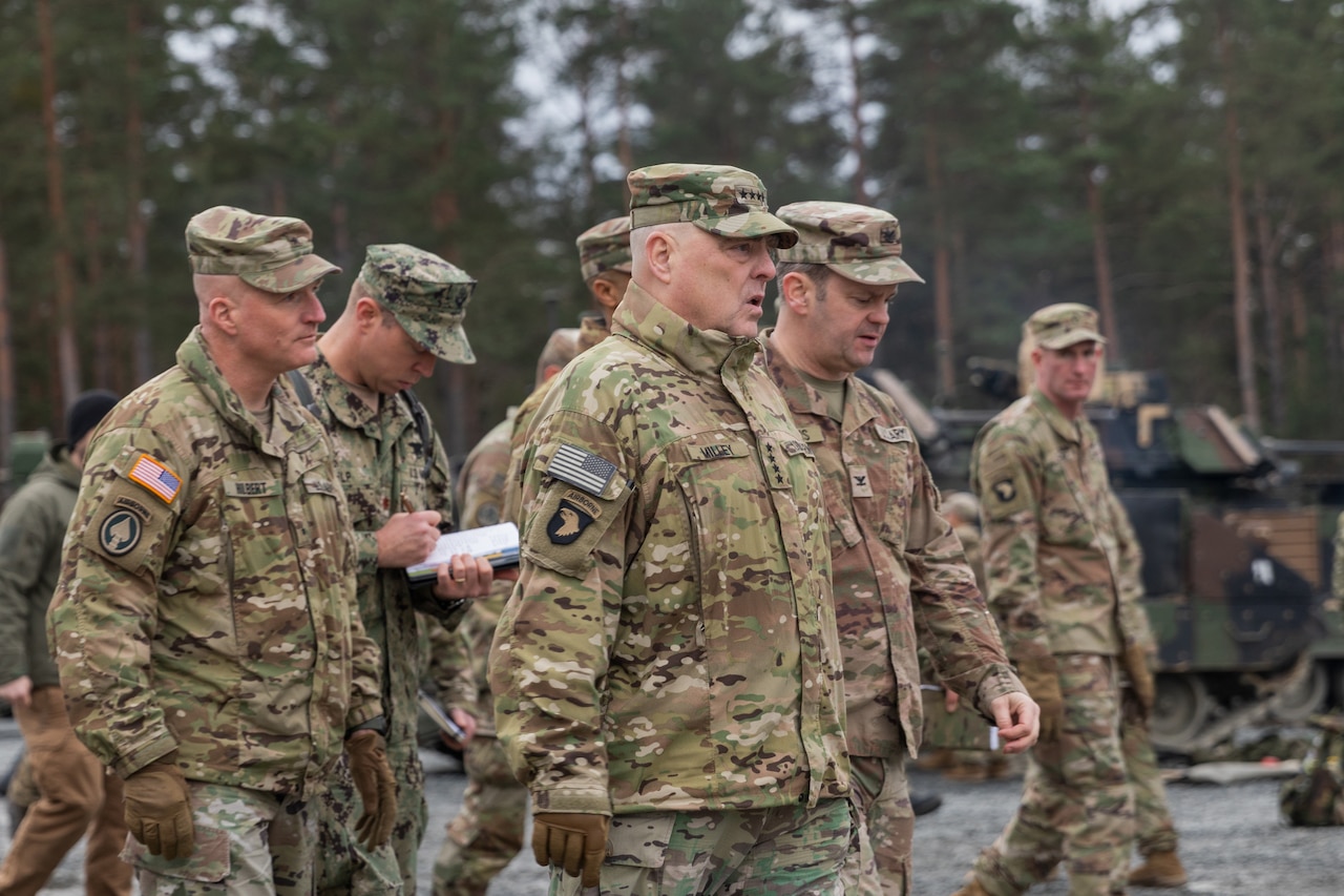 Men in military uniform walk together.