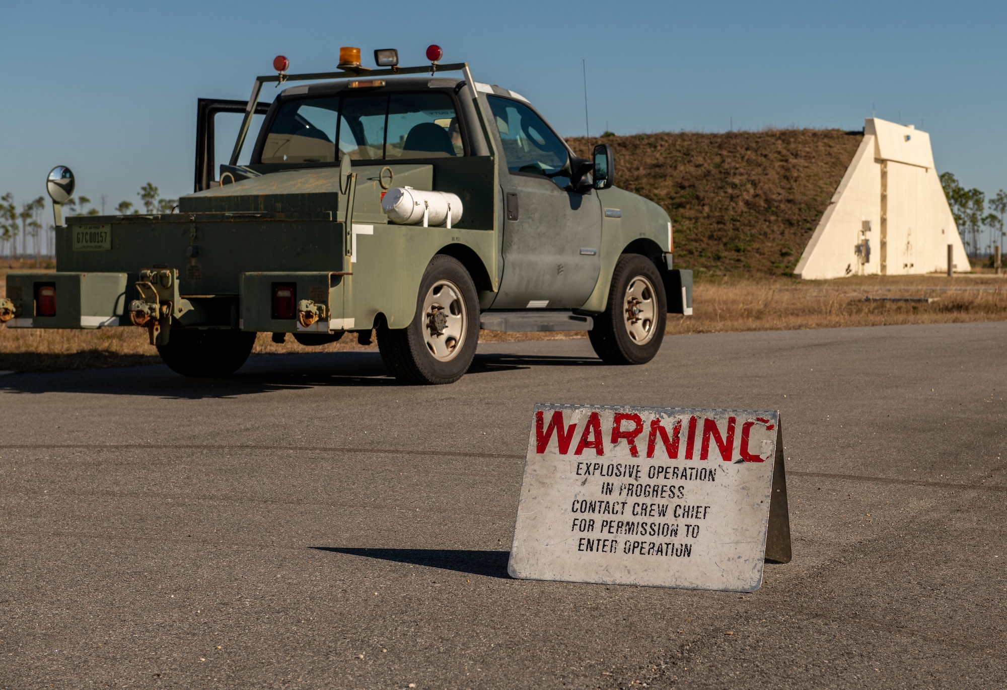 An explosive warning sign sits outside igloo