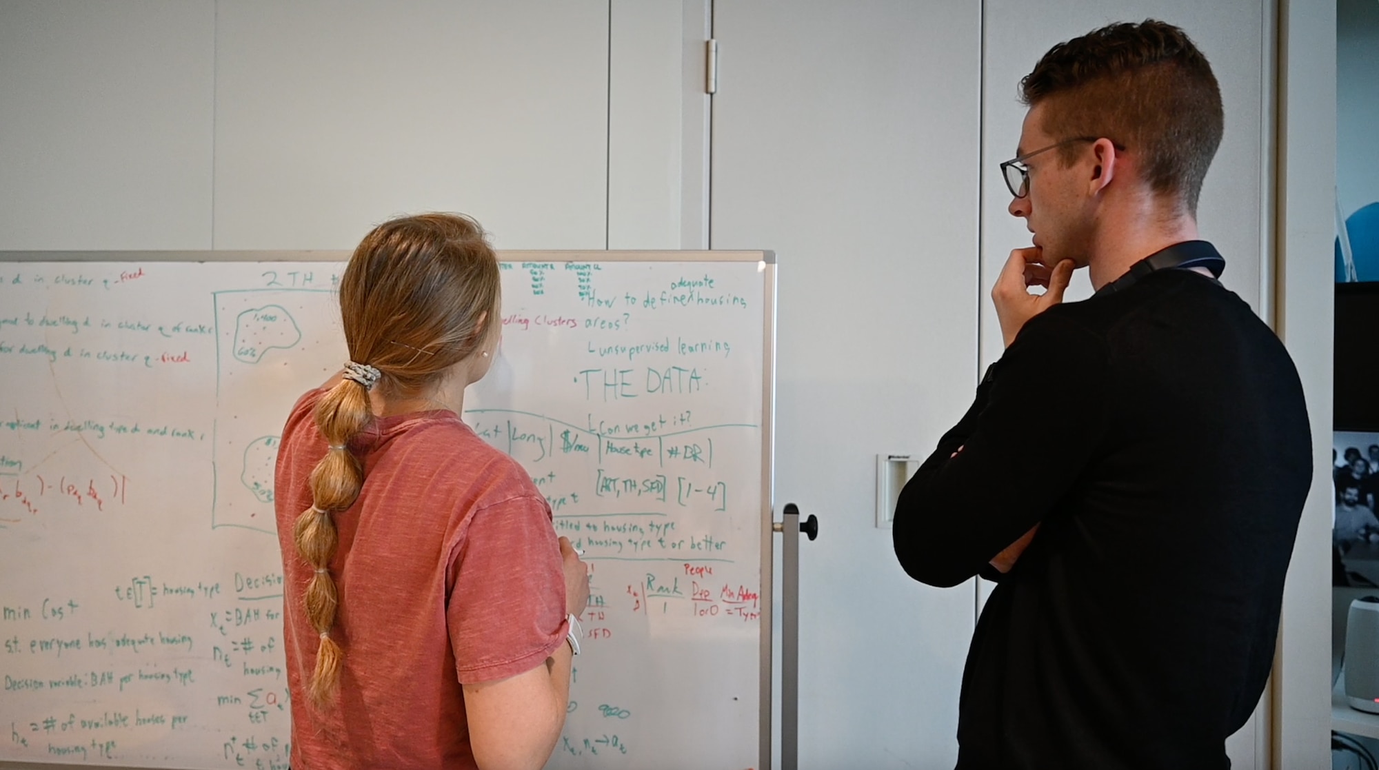 U.S. Air Force Capt. Lindsey McEvoy and 2nd Lt. Luke Kenworthy, members of the Phantom program assigned to the Department of the Air Force AI Accelerator, collaborating on data solutions for artificial intelligence for Basic Allowance in Cambridge, Mass. Oct. 20, 2022. (U.S. Air National Guard photo by Master Sgt. Amber Williams)