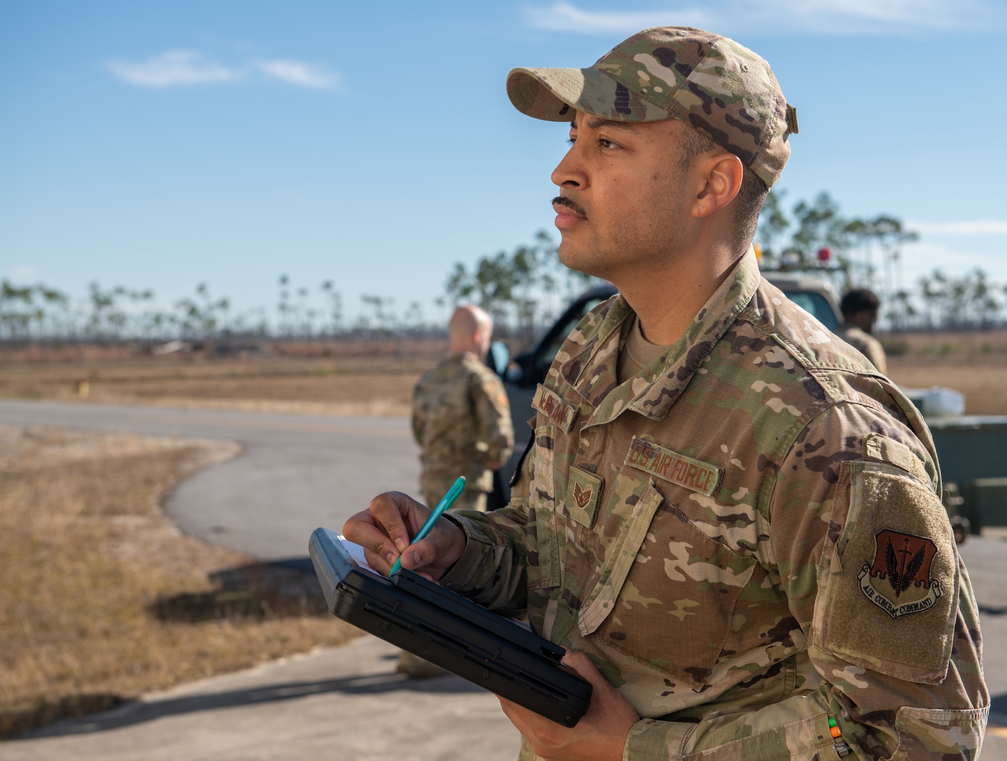 An airmen writes on a checklist