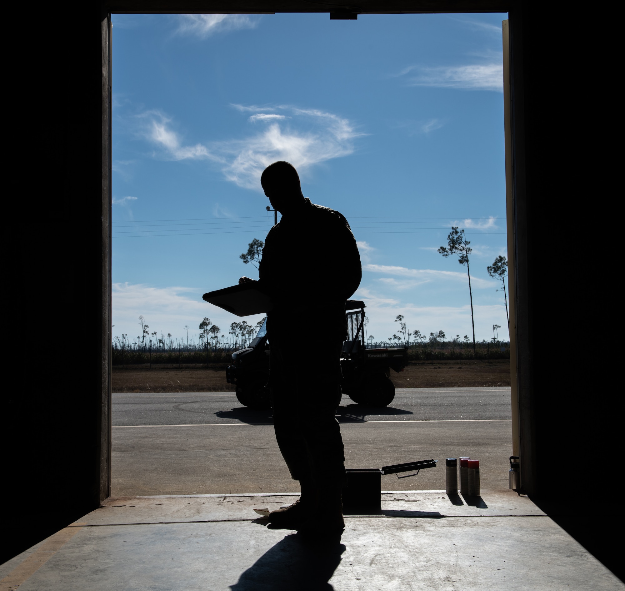 An airmen writes on checklist