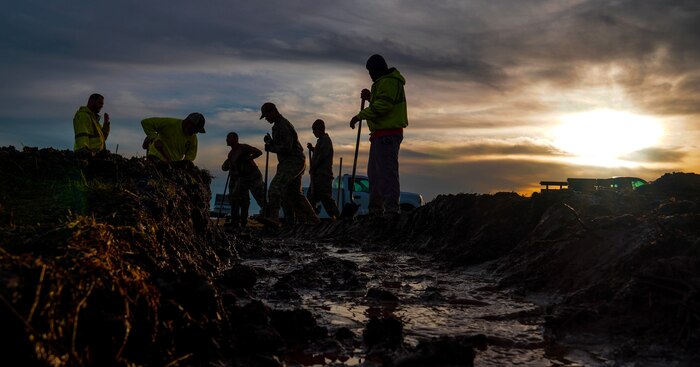 U.S. Air Force 9th Civil Engineer Squadron Airmen unblock a culvert Jan. 12, 2022, at Beale Air Force Base, Calif.