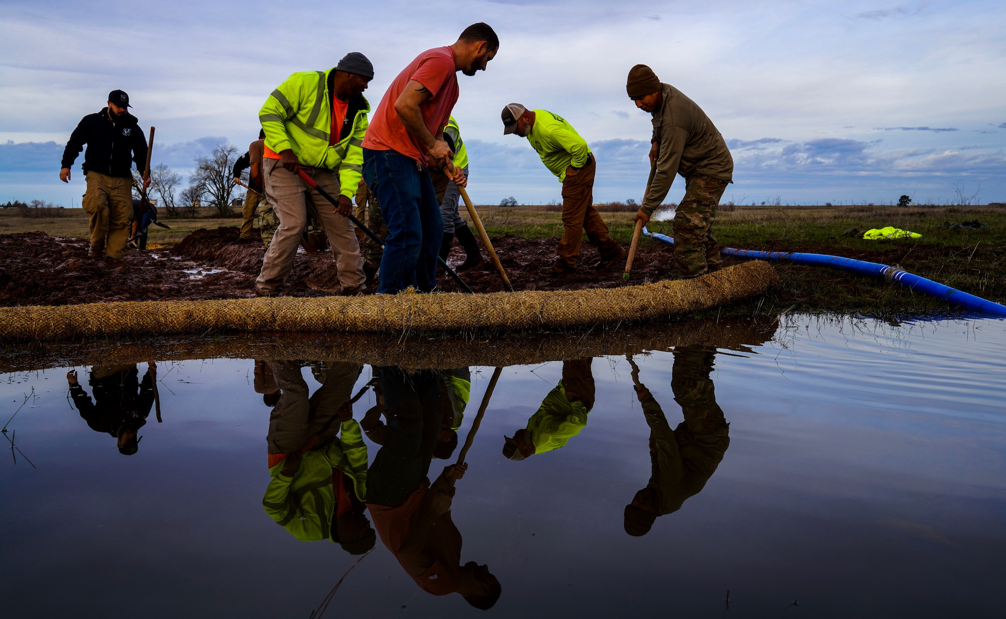 U.S. Air Force 9th Civil Engineer Squadron Airmen unblock a culvert Jan. 12, 2022, at Beale Air Force Base, Calif.