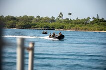 U.S. Marines with Force Recon Company, 3rd Recon Battalion, 3rd Marine Division, 3rd Marine Expeditionary Force, approach a vessel on a Combat Rubber Raiding Craft during a boarding rehearsal exercise part of Realistic Urban Training Exercise 23.1, Joint Base Pearl Harbor-Hickam, Hawaii, Jan. 10, 2023. The purpose of the RUTEX is to incorporate the specialized individual and small-unit skills of the MEU and conduct high-intensity, advanced, and complex Marine Air-Ground Task Force operations to prepare MEUs and other designated forces to support the geographic combatant commanders. (U.S. Marine Corps photo by Lance Cpl. Cody Purcell)