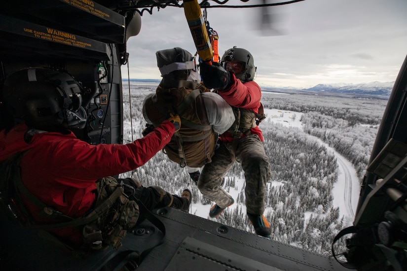 Special Tactics Airmen assigned to 24th Special Operations Wing, Detachment 1, conduct an aerial insertion and field training exercise at Camp Mad Bull training site on Joint Base Elmendorf-Richardson, Alaska, Jan. 10, 2023. The 24 SOW Det 1 Special Tactics Airmen are capable of assessing and opening anything from a major international airport to clandestine dirt strips in either permissive or hostile locations, providing strategic access for follow-on forces during global contingencies, and joint readiness exercises. Alaska Army National Guardsmen assigned to the 207th Aviation Battalion flew UH-60L and HH-60M Black Hawk helicopters in order to support the aerial insertion, medical evacuation and hoist training of the Special Tactics teams. The Alaska Army National Guard’s GSAB routinely trains with all branches of the military as well as civilian agencies to increase its operational interoperability and to be ready for a wide range of federal and state missions.