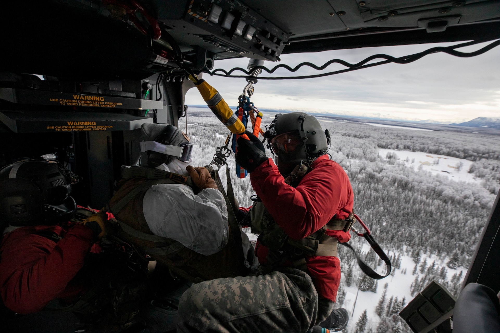 Special Tactics Airmen assigned to 24th Special Operations Wing, Detachment 1, conduct an aerial insertion and field training exercise at Camp Mad Bull training site on Joint Base Elmendorf-Richardson, Alaska, Jan. 10, 2023. The 24 SOW Det 1 Special Tactics Airmen are capable of assessing and opening anything from a major international airport to clandestine dirt strips in either permissive or hostile locations, providing strategic access for follow-on forces during global contingencies, and joint readiness exercises. Alaska Army National Guardsmen assigned to the 207th Aviation Battalion flew UH-60L and HH-60M Black Hawk helicopters in order to support the aerial insertion, medical evacuation and hoist training of the Special Tactics teams. The Alaska Army National Guard’s GSAB routinely trains with all branches of the military as well as civilian agencies to increase its operational interoperability and to be ready for a wide range of federal and state missions.