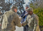 Two men shake hands