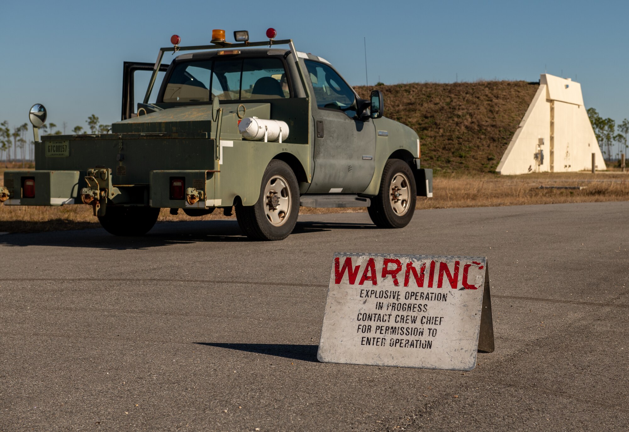 An explosive warning sign sits outside igloo