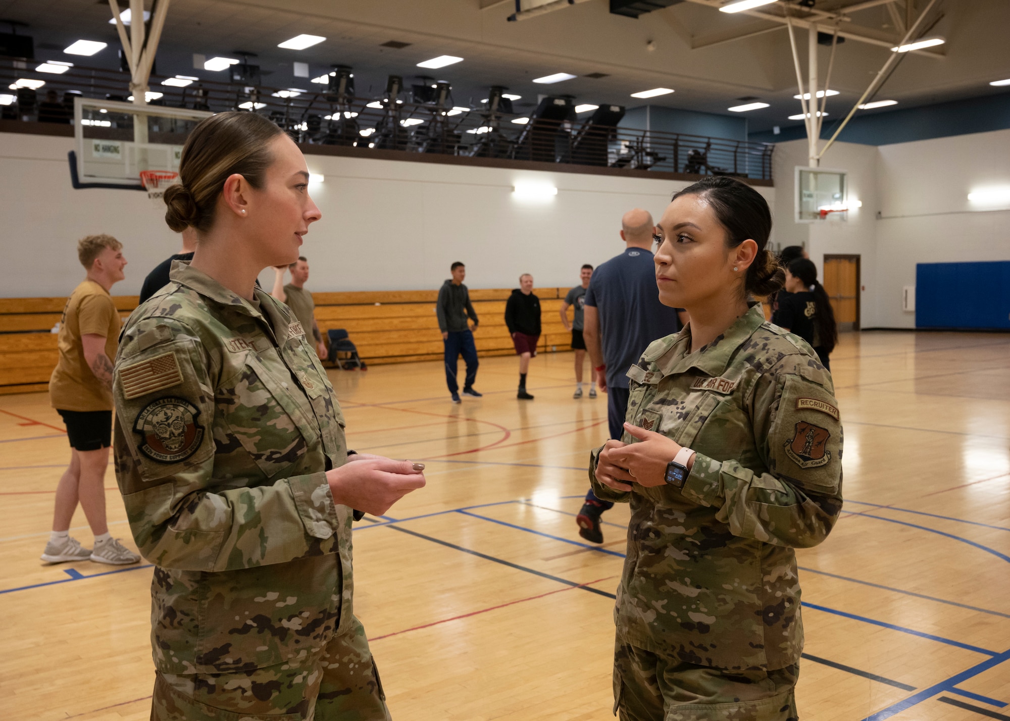 Tech. Sgt. Sophie Stewart, a 162nd Wing production recruiter, discusses the morning physical training plan for student flight with Staff Sgt. Judith Lopez, also a 162nd Wing production recruiter. The student flight, comprised of members that have enlisted but have not attended basic training, report to the wing recruiters each drill weekend. (U.S. Air National Guard photo by Tech. Sgt. George Keck)