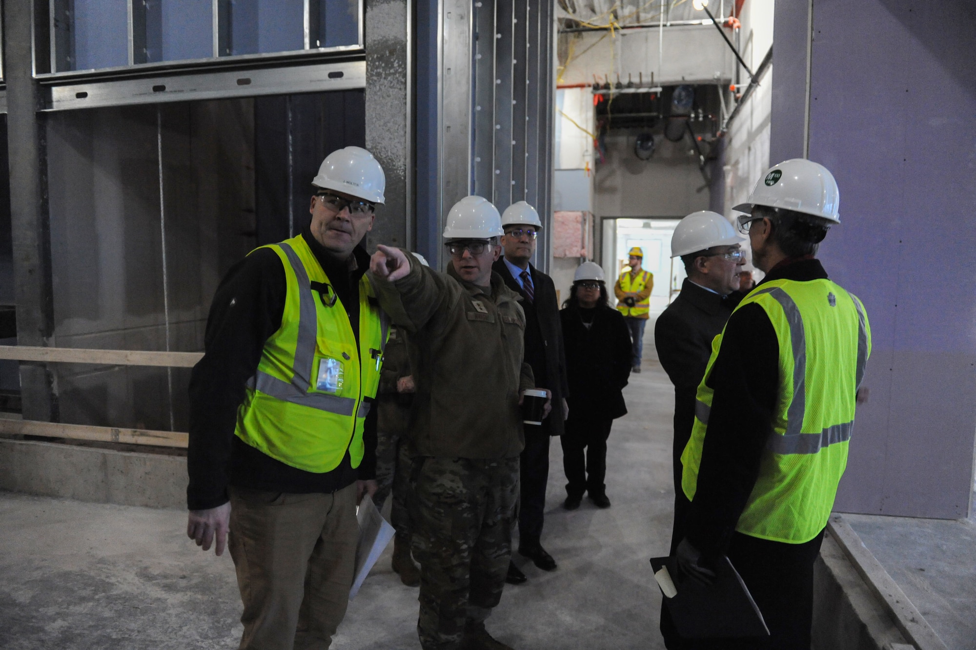 Maj. Gen. Parker H. Wright, Intelligence and Information director, North American Aerospace Defense Command and United States Northern Command, points to a newly constructed area within the Intelligence Production Center III during his tour of the building at Wright-Patterson Air Force Base, Ohio, Jan. 11, 2023. Expected to finish in 2024, the 255,000 square-foot building will add 980 workstations, mission-specific functions, meeting areas, and advanced visualization capabilities to the NASIC campus.