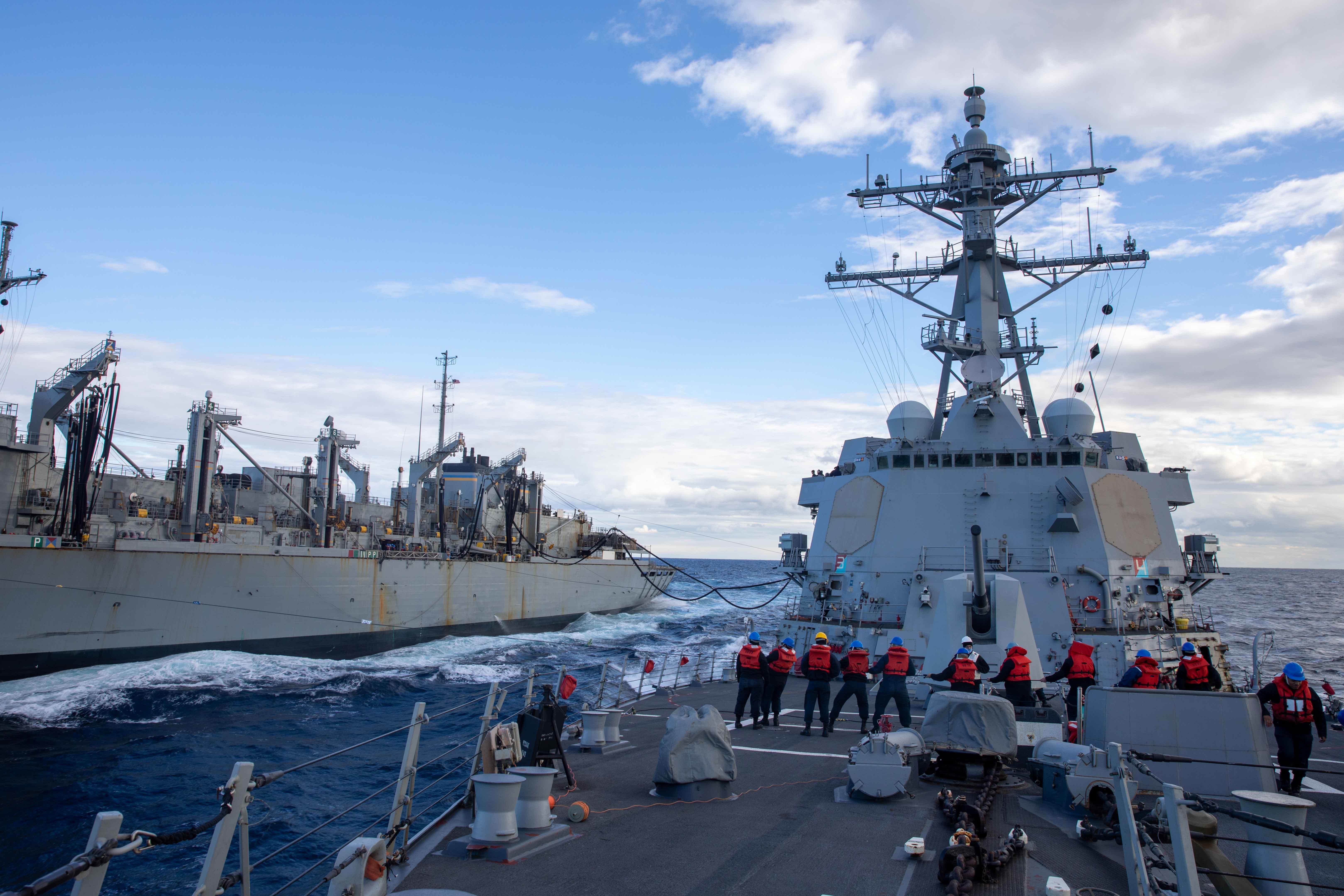 The Arleigh Burke-class guided-missile destroyer USS Nitze (DDG 94) completes a replenishment-at-sea with the Supply-class fast combat support ship USNS Arctic (T-AOE 8), Jan. 11, 2023.