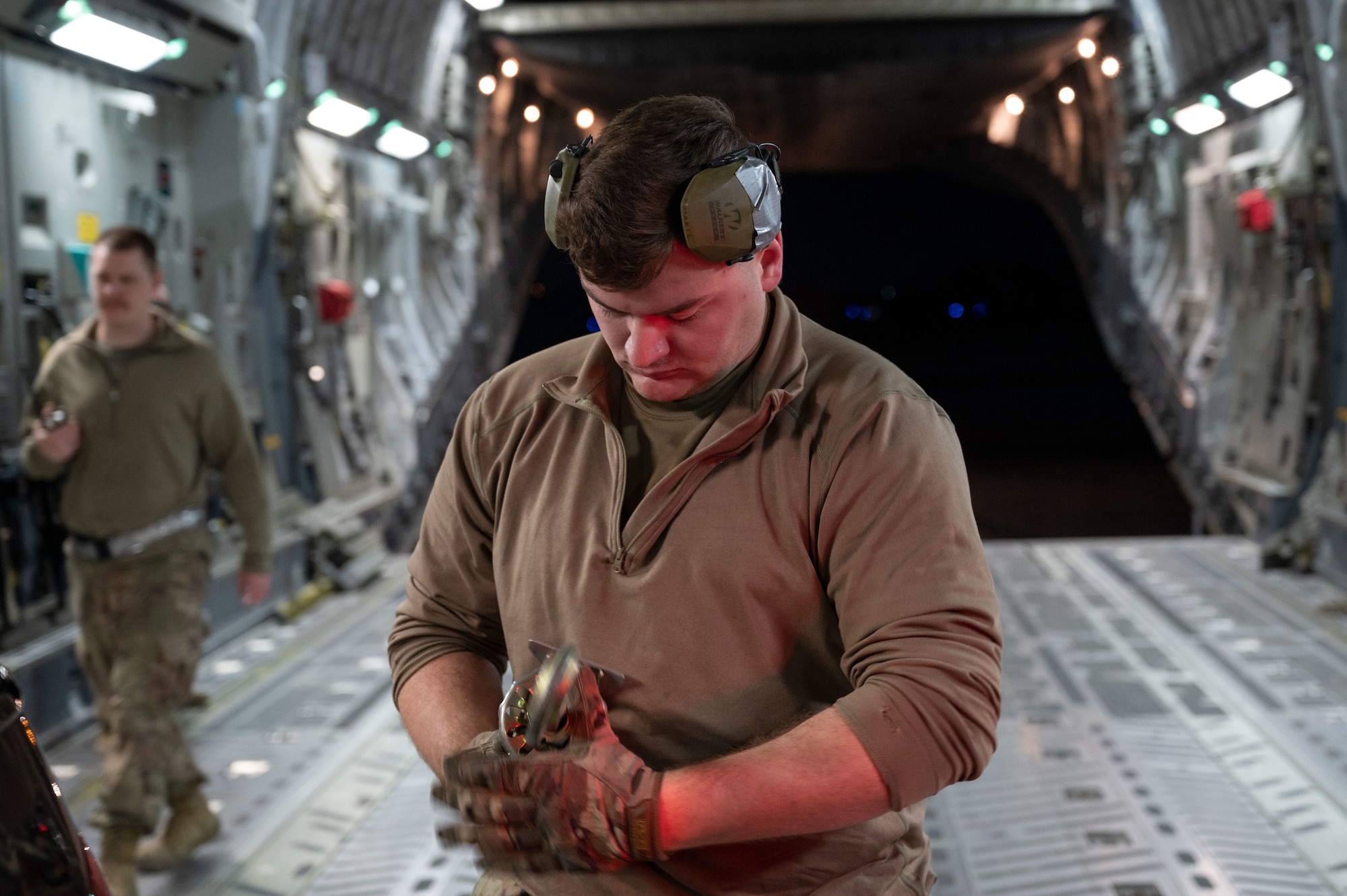 U.S. Air Force Airman 1st Class Matthew Martz, a 386th Expeditionary Logistics Readiness Squadron air transportation specialist, prepares to secure a compact pick-up truck in a C-17 Globemaster III