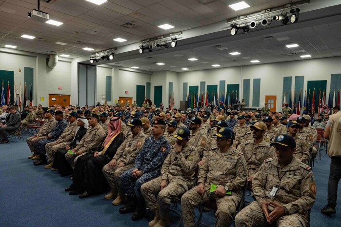 230118-N-EG592-1010 MANAMA, Bahrain (Jan. 18, 2023) A multinational audience listens to remarks during a change of command ceremony, Jan. 18, in Manama, Bahrain. United Kingdom’s Royal Navy Capt. James Byron assumed command of Combined Task Force 150 which had been led by Royal Saudi Naval Forces Rear Adm. Abdullah Al-Mutairi since July.