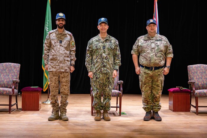 230118-N-EG592-1032 MANAMA, Bahrain (Jan. 18, 2023) From left to right, Royal Saudi Naval Forces Rear Adm. Abdullah Al-Mutairi; Vice Adm. Brad Cooper, commander of U.S. Naval Forces Central Command, U.S. 5th Fleet and Combined Maritime Forces; and United Kingdom’s Royal Navy Capt. James Byron stand at attention during a change of command ceremony, Jan. 18, in Manama, Bahrain. Byron assumed command of Combined Task Force 150 which had been led by Al-Mutairi since July.