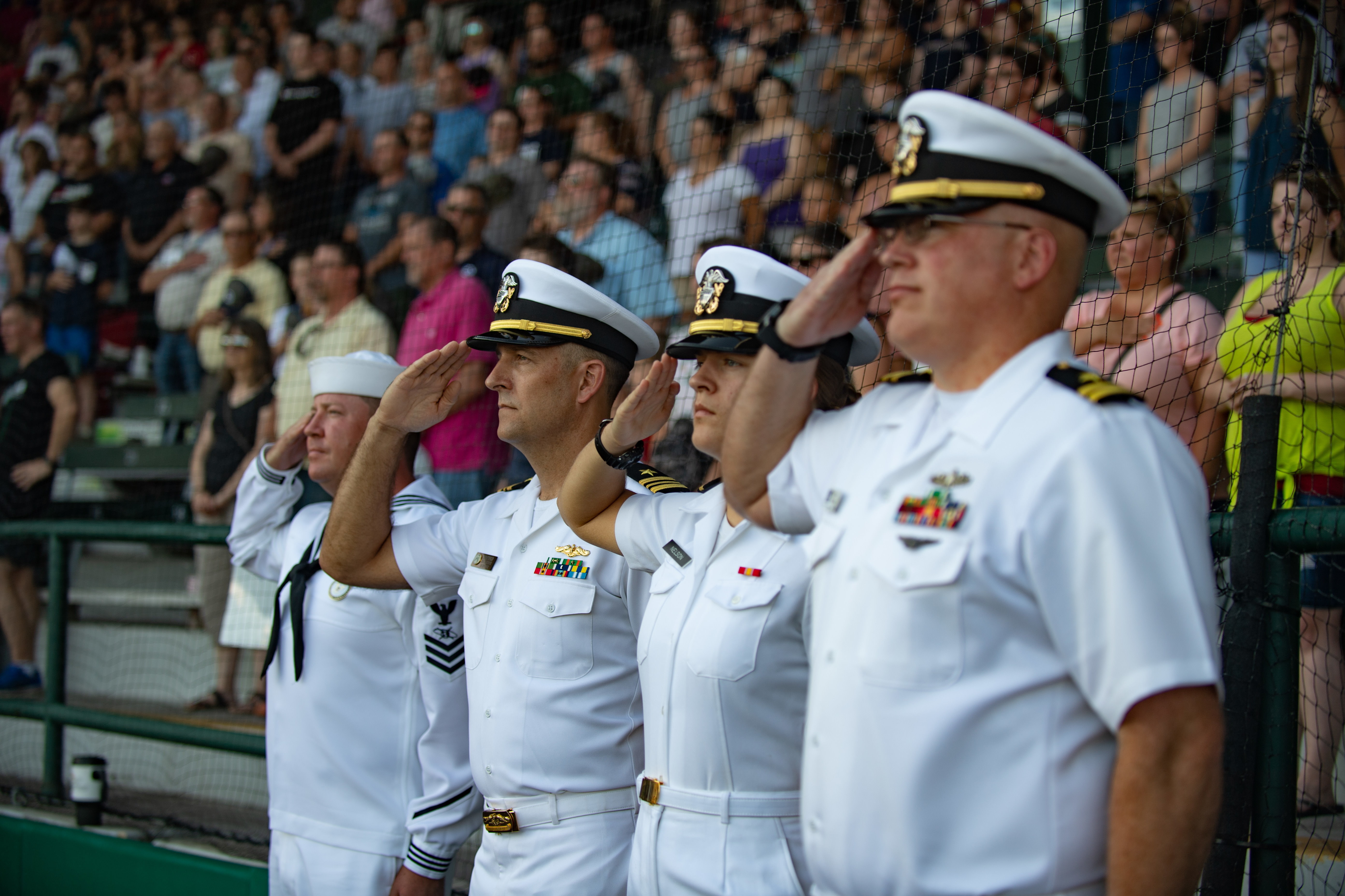 Sailors salute during the national anthem