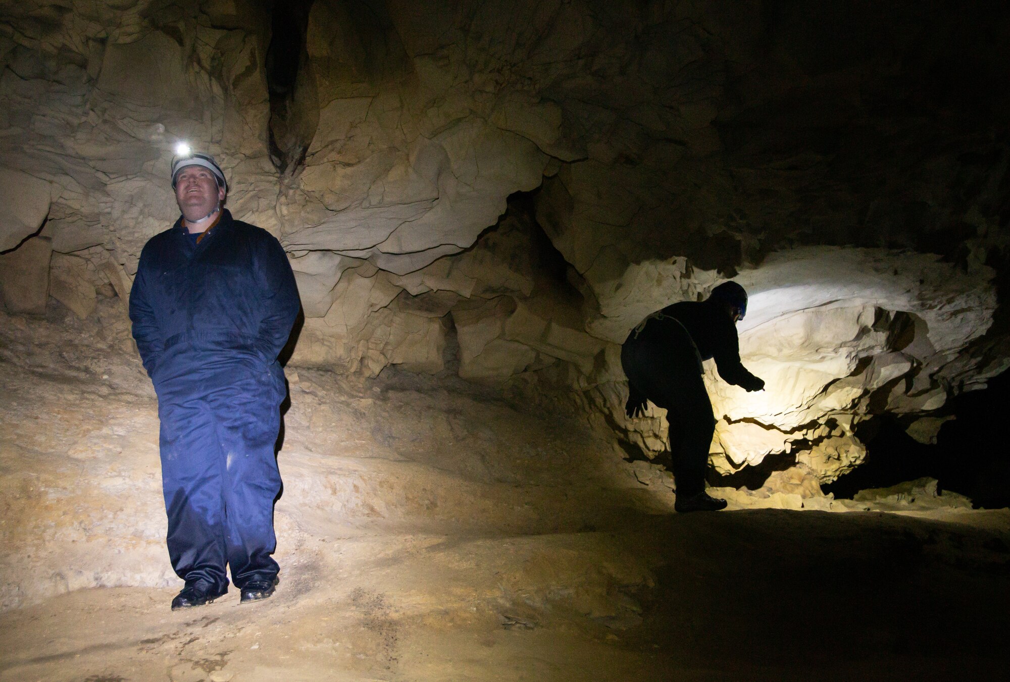 People searching a cave for bats