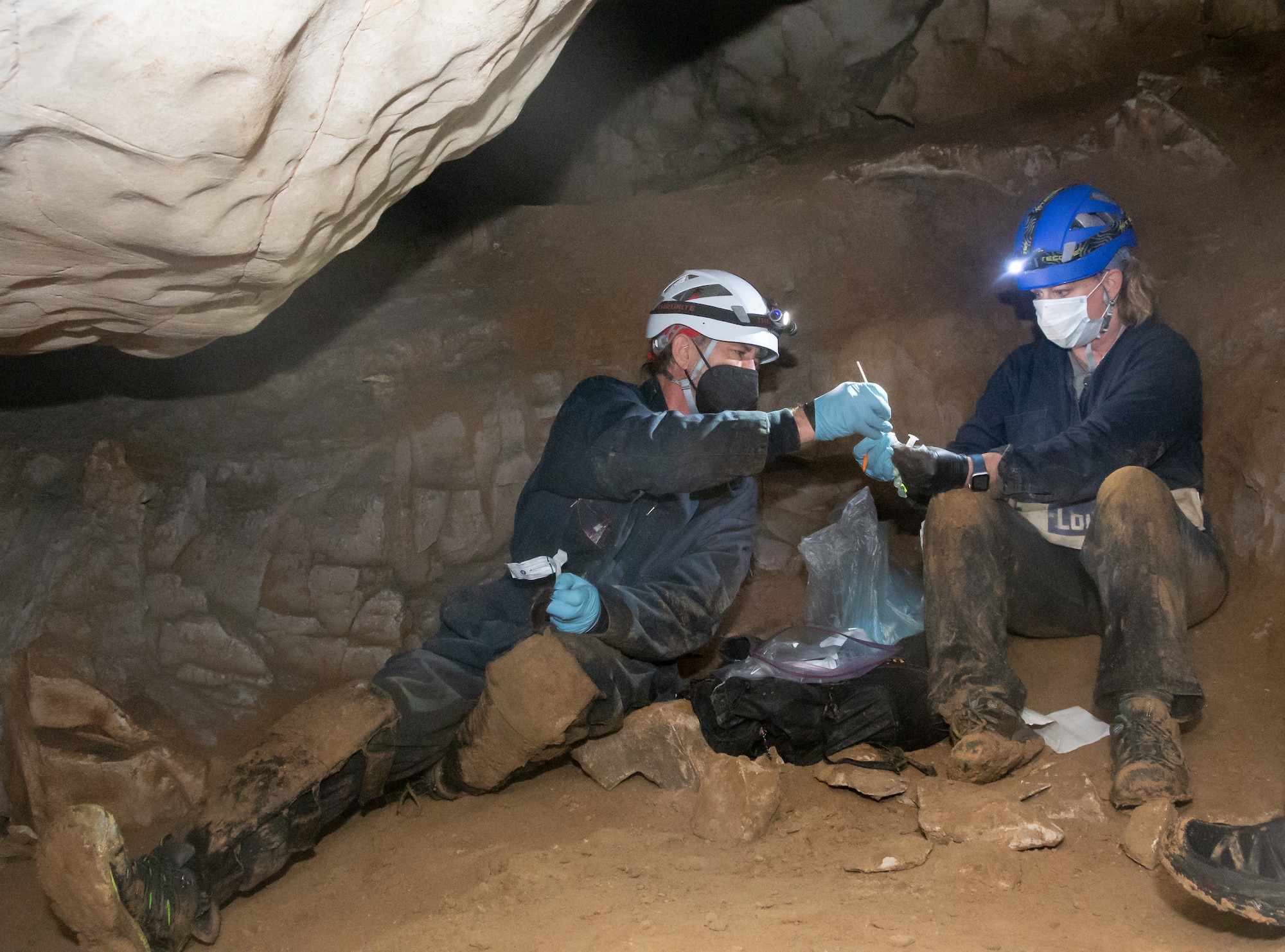 Two biologists in a cave