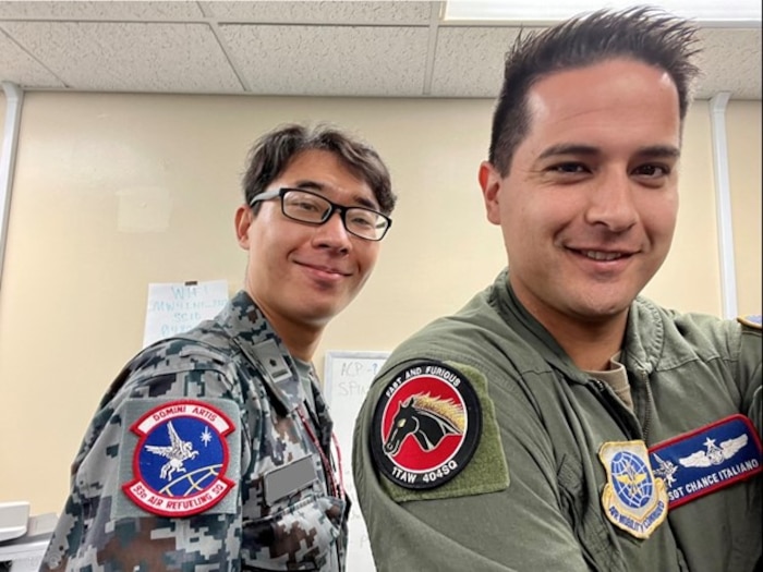 Japanese Self-Defense Forces member and U.S. Airman posing for a picture